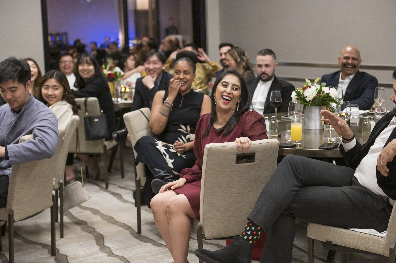 Guests smiling and laughing during a John Ha performance