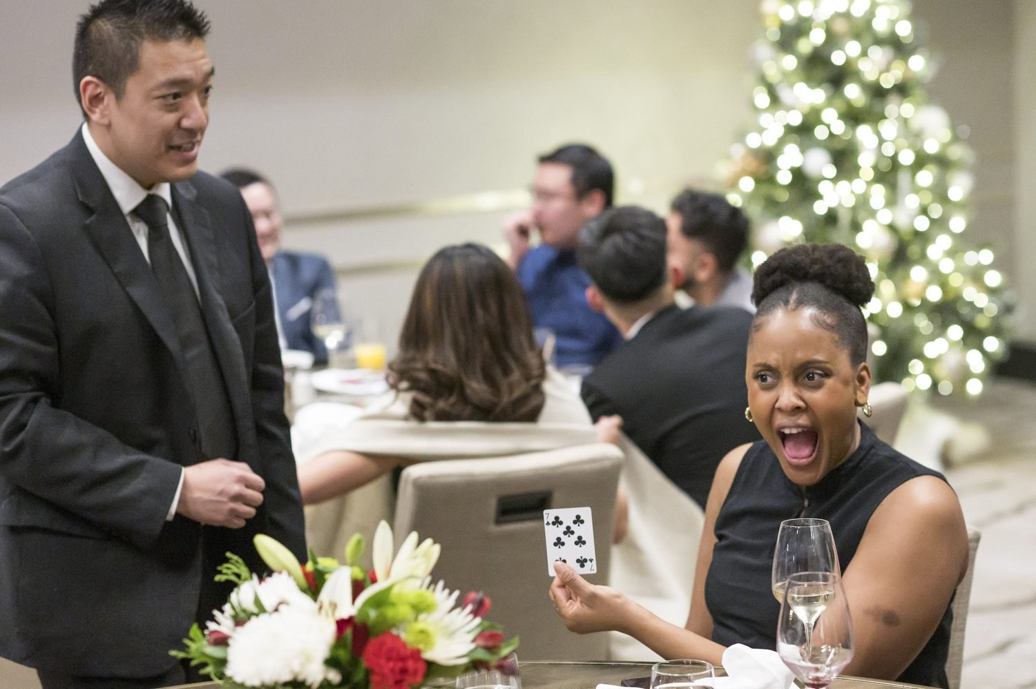 Guest reacting with surprise and smiles during close-up magic