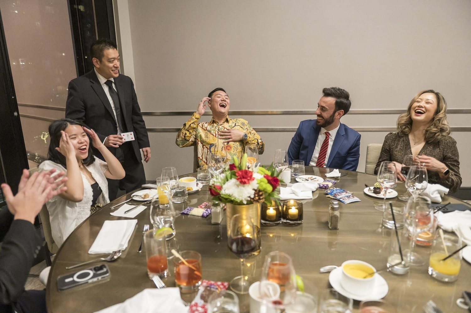 Dinner guests reacting around a table