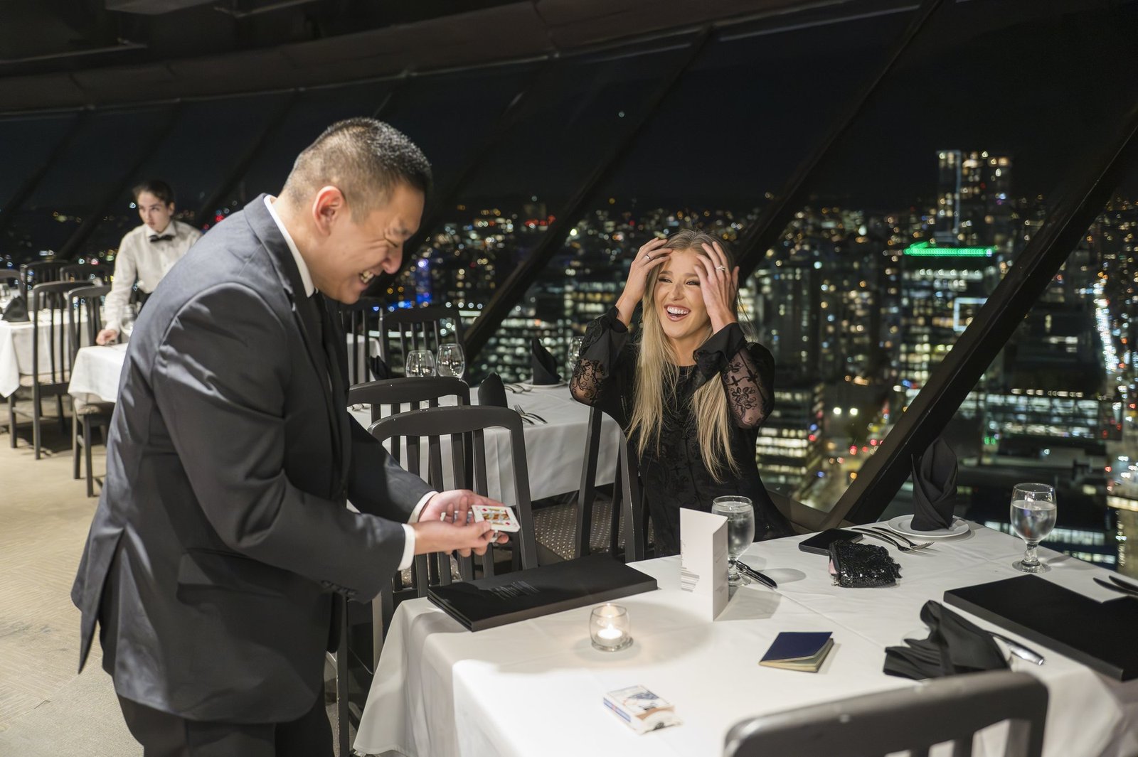 VIP dinner guest laughing during close-up magic